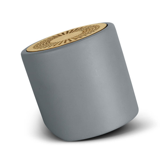A grey limestone Bluetooth mini speaker with a wooden top, featuring a circular design and a brand logo.