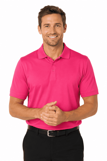 A man wearing a vibrant pink polo shirt, smiling with hands clasped, paired with black trousers. The shirt features a logo.