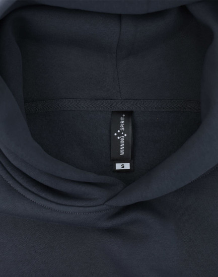 A dark grey oversized hoodie featuring an internal label and a hood design. Contains a branding logo.