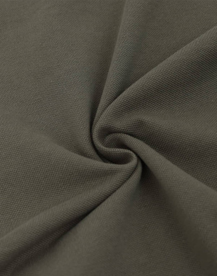 A close-up of dark olive green fabric with a soft texture, featuring a pique weave pattern.