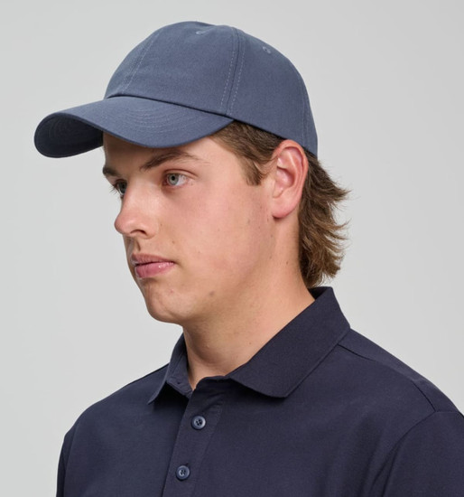 A cotton twill unstructured cap in navy blue, featuring a curved brim and an adjustable strap at the back.