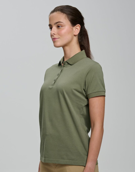 A woman wearing an olive green ultrafine cotton pique polo with a classic collar and short sleeves.