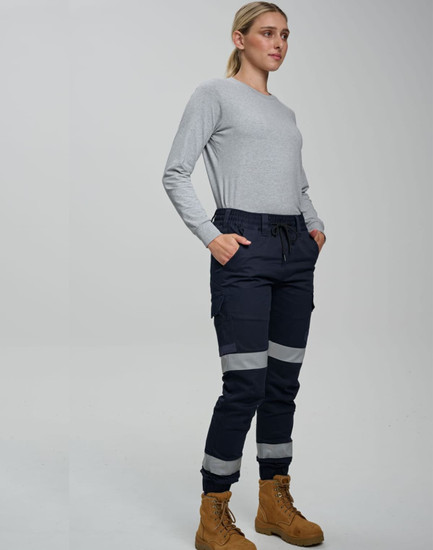 Cotton stretch drill cuffed work pants in navy with reflective tape, worn by a model with a grey long-sleeve top and boots.