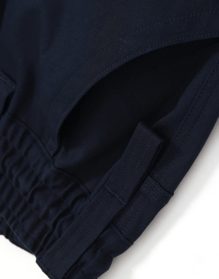 Navy cotton stretch drill cuffed work pants featuring tape detailing and an elastic waistband. Includes a logo.