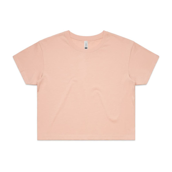 A cropped tee in a soft peach colour with a relaxed fit and short sleeves. It features a branding label.