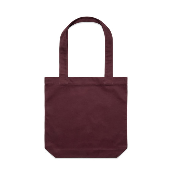 A maroon tote bag with two long handles and a plain design, featuring a logo on one side.