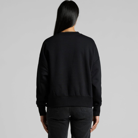 A black crew jumper featuring a relaxed fit and ribbed cuffs, shown from the back. The model is wearing black jeans.