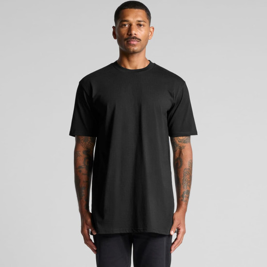 A black classic plus tee with short sleeves, featuring a logo, displayed on a model.