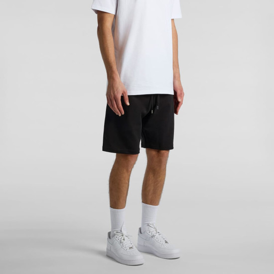 Black sports shorts with a drawstring, featuring a logo, worn with a white T-shirt and white sneakers.