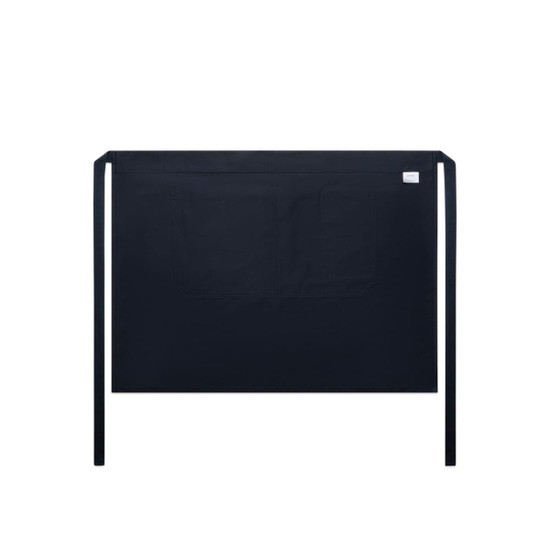 A black half apron featuring a front pocket and ties at the waist. It includes a branding label.