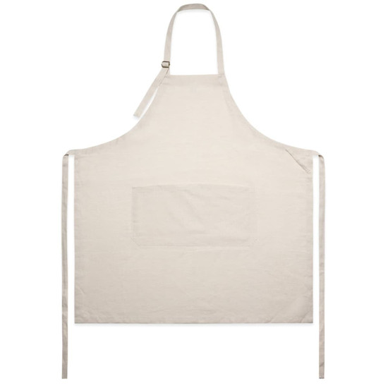 A linen apron in cream with a front pocket, featuring adjustable straps and ties at the sides.