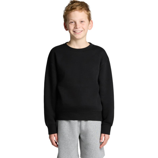A black sweater worn by a smiling boy, paired with grey shorts, features a simple design and has a logo.