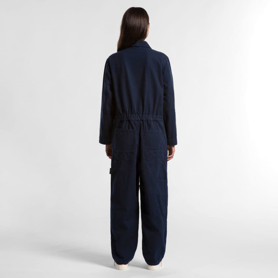 A person wearing navy canvas coveralls viewed from the back, featuring a relaxed fit and elasticised waist.