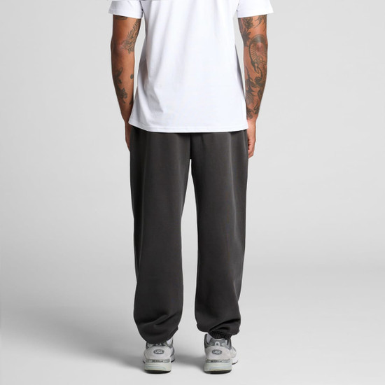 Faded track pants in dark grey, featuring a relaxed fit with a waistband and a logo.