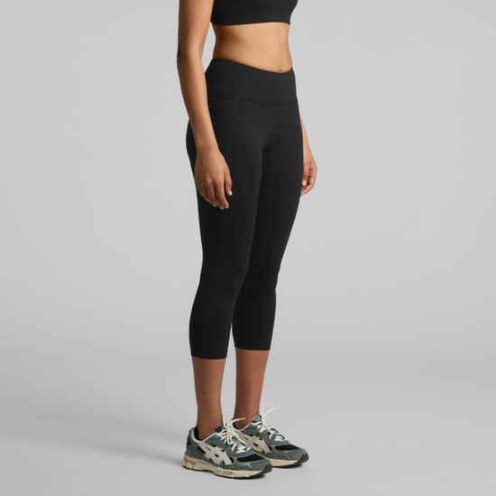 Black mid-length leggings displayed on a model, paired with athletic shoes, featuring a simple design and a logo.