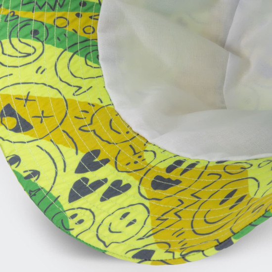 A yellow and green bucket hat featuring playful cartoon-style designs and an inner lining, with a branding patch.