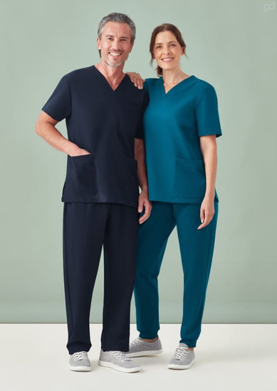 A unisex V-neck scrub top in teal and navy, displayed on male and female models. Both feature pockets.