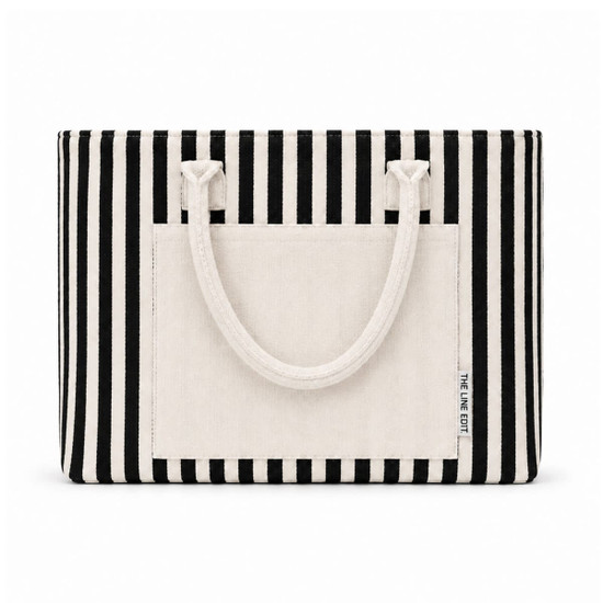 A striped tote bag in black and cream with sturdy handles and a front pocket, featuring a logo.