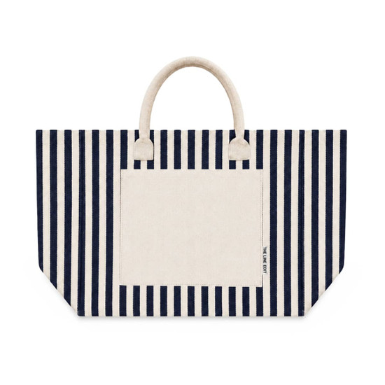 A striped tote bag featuring navy blue and cream colours with two handles and a front pocket. It has a logo.