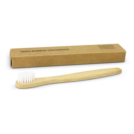A bamboo toothbrush with a light wooden handle and white bristles, alongside a brown cardboard box.