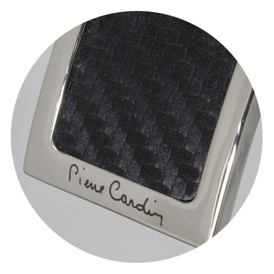 A sleek key ring featuring a textured black surface and a metallic silver frame, with branding.