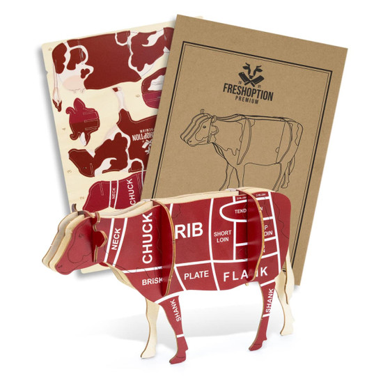 A wooden model of a cow in red and cream, featuring anatomical cuts, accompanied by two instructional booklets.