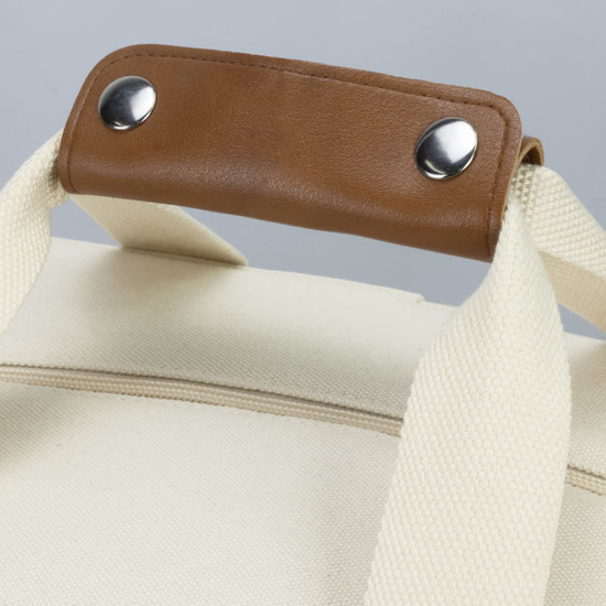A cream cooler tote bag with a sturdy brown handle and silver studs, featuring a fabric exterior.