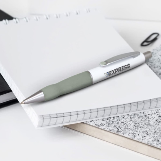 A metal pen with a white barrel and grey grip, placed on a notepad among other stationery items.