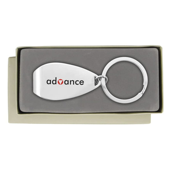 A silver keychain in a grey box, featuring a smooth, metallic surface and a circular ring.