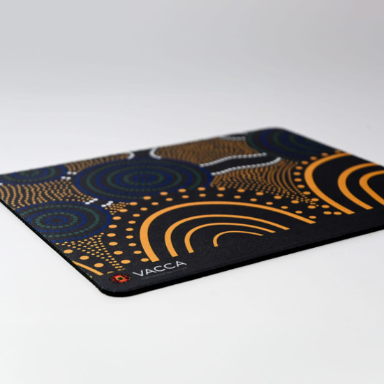 A patterned mouse mat featuring blue, orange, and black colours with a logo in one corner.