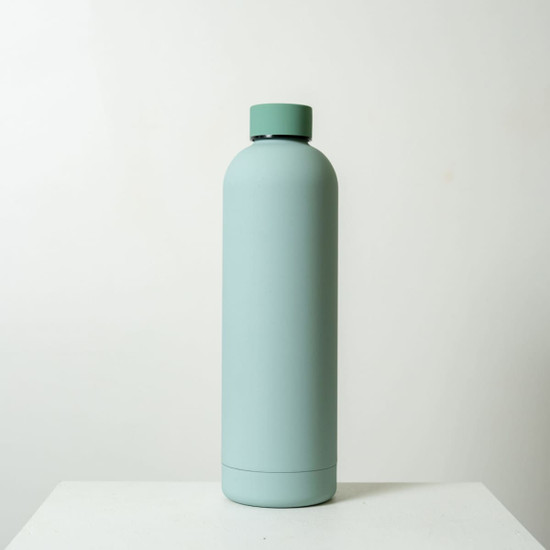 A drink bottle with a smooth, mint green finish and a rounded cap, featuring a minimalistic design.