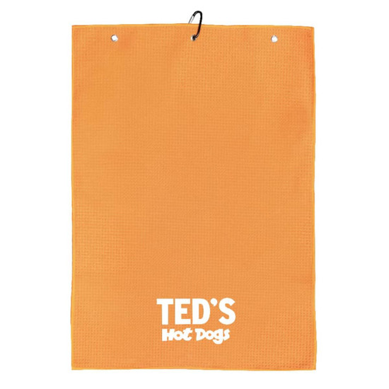 An orange golf towel with a textured surface and a logo at the bottom. It features two hanging holes.