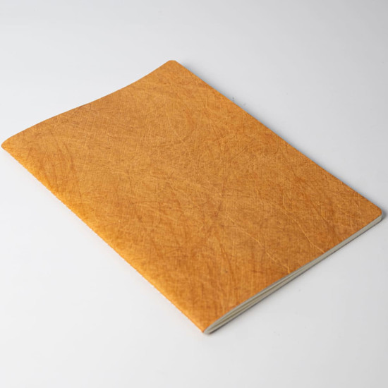 A notebook with a textured orange cover, featuring a simple design without visible branding.