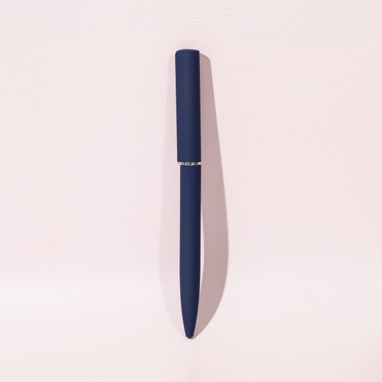 A blue ballpoint pen with a mirror finish, featuring a sleek design and a branding logo.