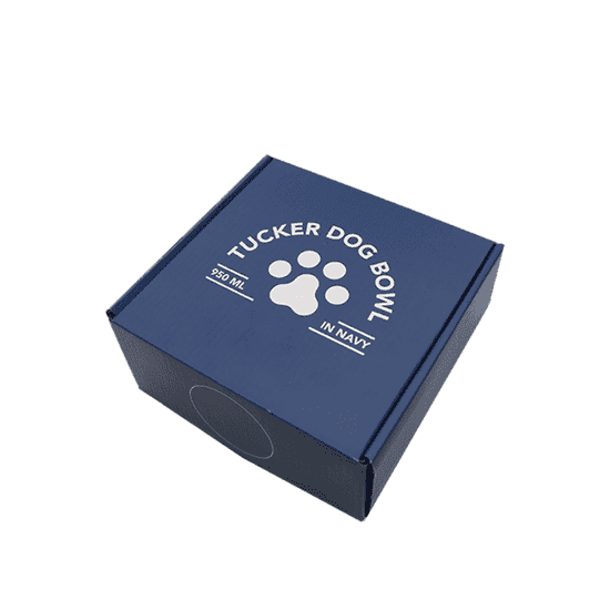 A navy blue box containing the Tucker Dog Bowl, featuring a paw print design and branding on the lid.