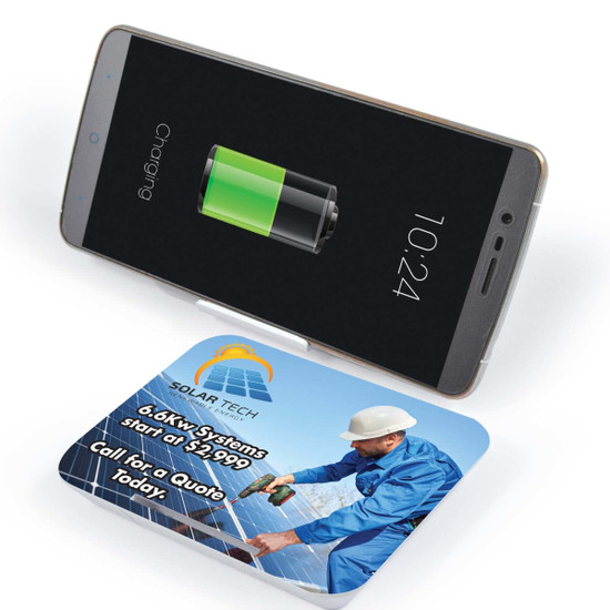 A wireless charger with a sleek design and a smartphone on top displaying a battery charging icon.