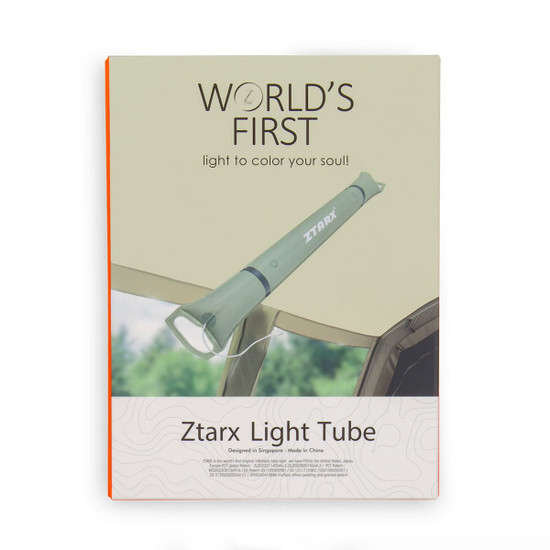 A green foldable camp light is displayed against a natural background, featuring a logo on the product.