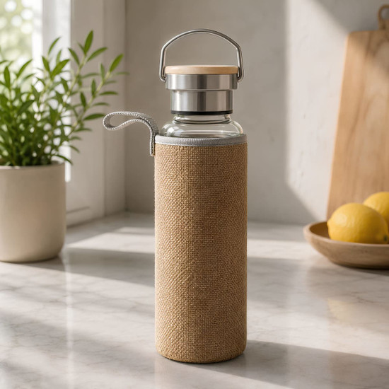 A drink bottle featuring a glass body, a metal lid, and a tan fabric sleeve, set on a kitchen countertop.