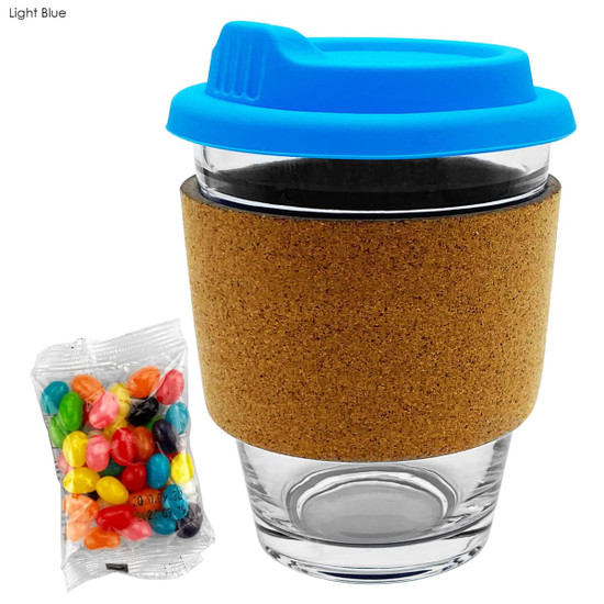 A glass coffee cup with a light blue lid and cork band, accompanied by a bag of colourful jelly beans.