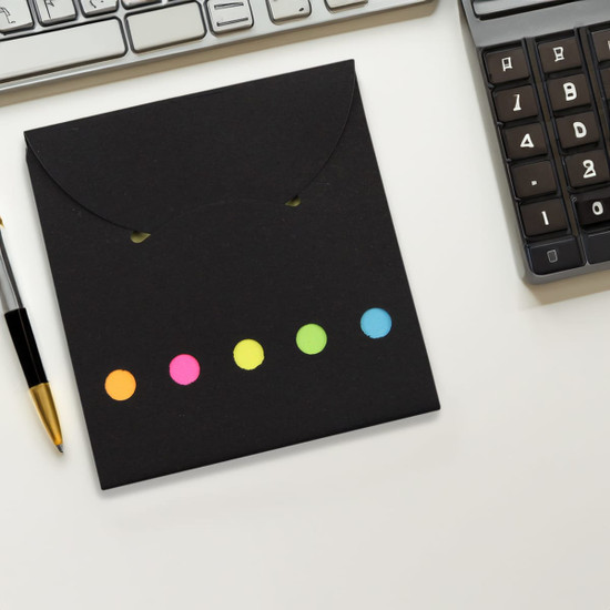 A black sticky note pad with colourful dots in pink, orange, yellow, green, and blue. Includes a logo.