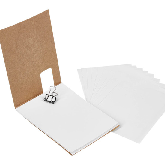A Flexi Notebook featuring a brown cover, white blank pages, and a black binder clip holding the sheets together.