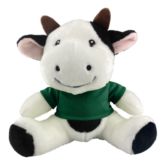 A plush cow toy featuring black and white fur with a green shirt, smiling with ear and horn details.