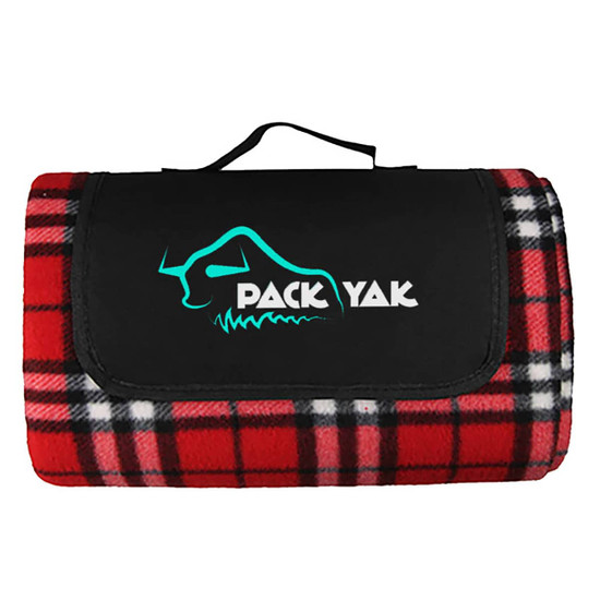 A red and black checkered picnic blanket featuring a black flap and a logo. It has a carrying handle for convenience.