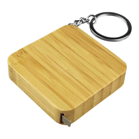 A bamboo tape measure key ring with a square design and a metal key ring attachment.