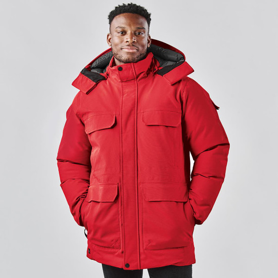 A red Men's Denali Parka jacket featuring multiple front pockets and a hood, with a logo present.