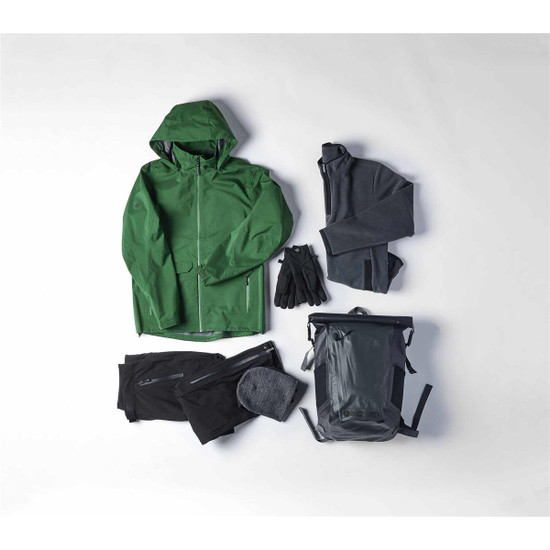 A green waterproof jacket, grey fleeces, black pants, gloves, a beanie, and a grey backpack arranged together.