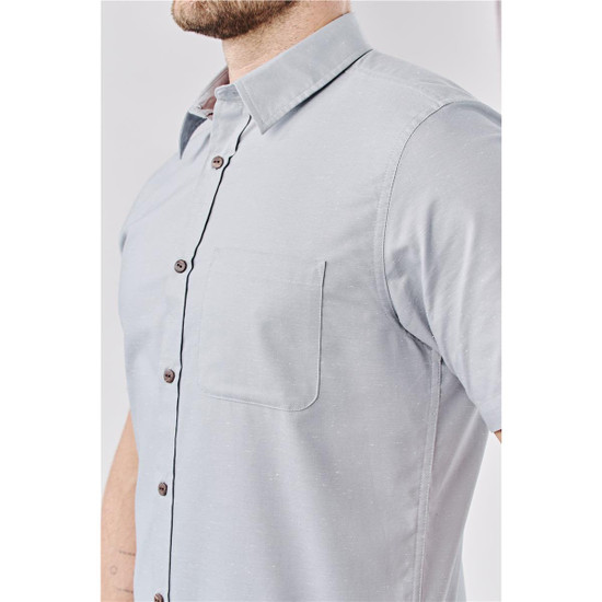 A light grey button-up shirt with short sleeves, featuring a chest pocket and a logo.