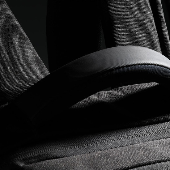 A black backpack featuring padded straps and textured fabric, with a small logo visible.