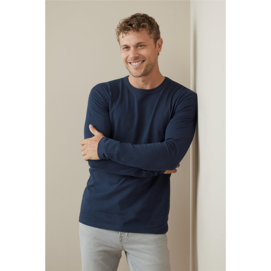A long sleeve men's shirt in navy blue, featuring a simple design and a logo on the chest.