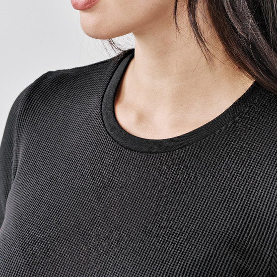 A close-up of a black crew neck shirt featuring a textured fabric and a round neckline.